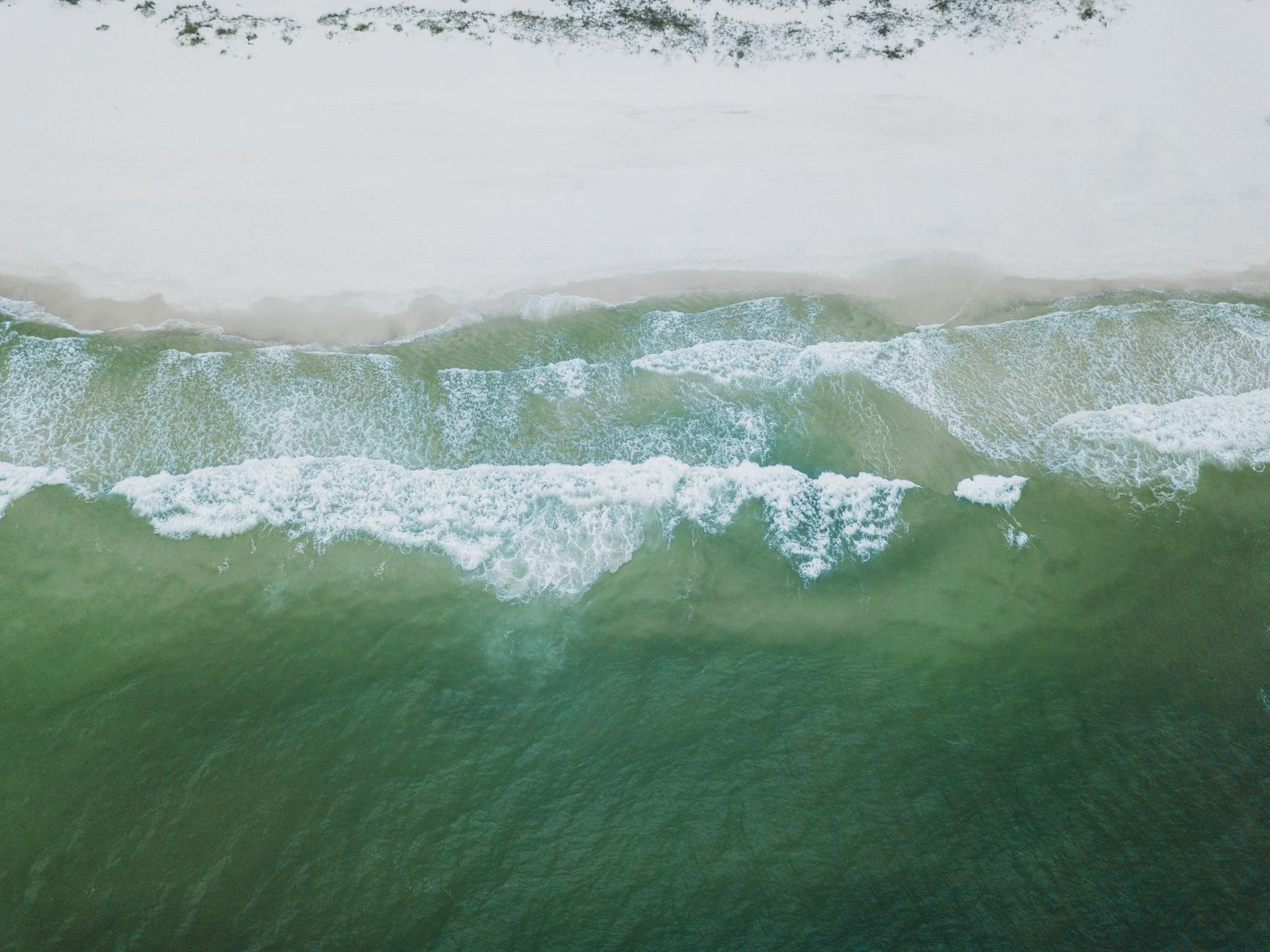 Drone capture of waves meeting the sandy shores at Orange Beach, Alabama.